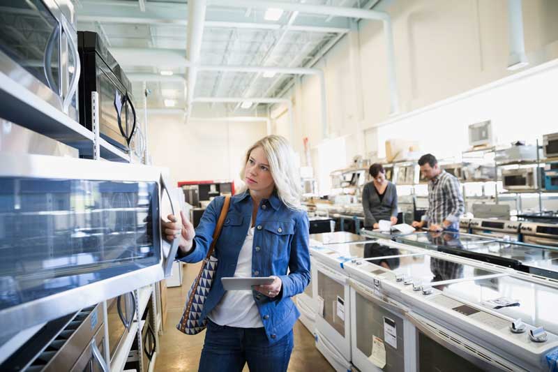 Woman looking at appliances in a showroom